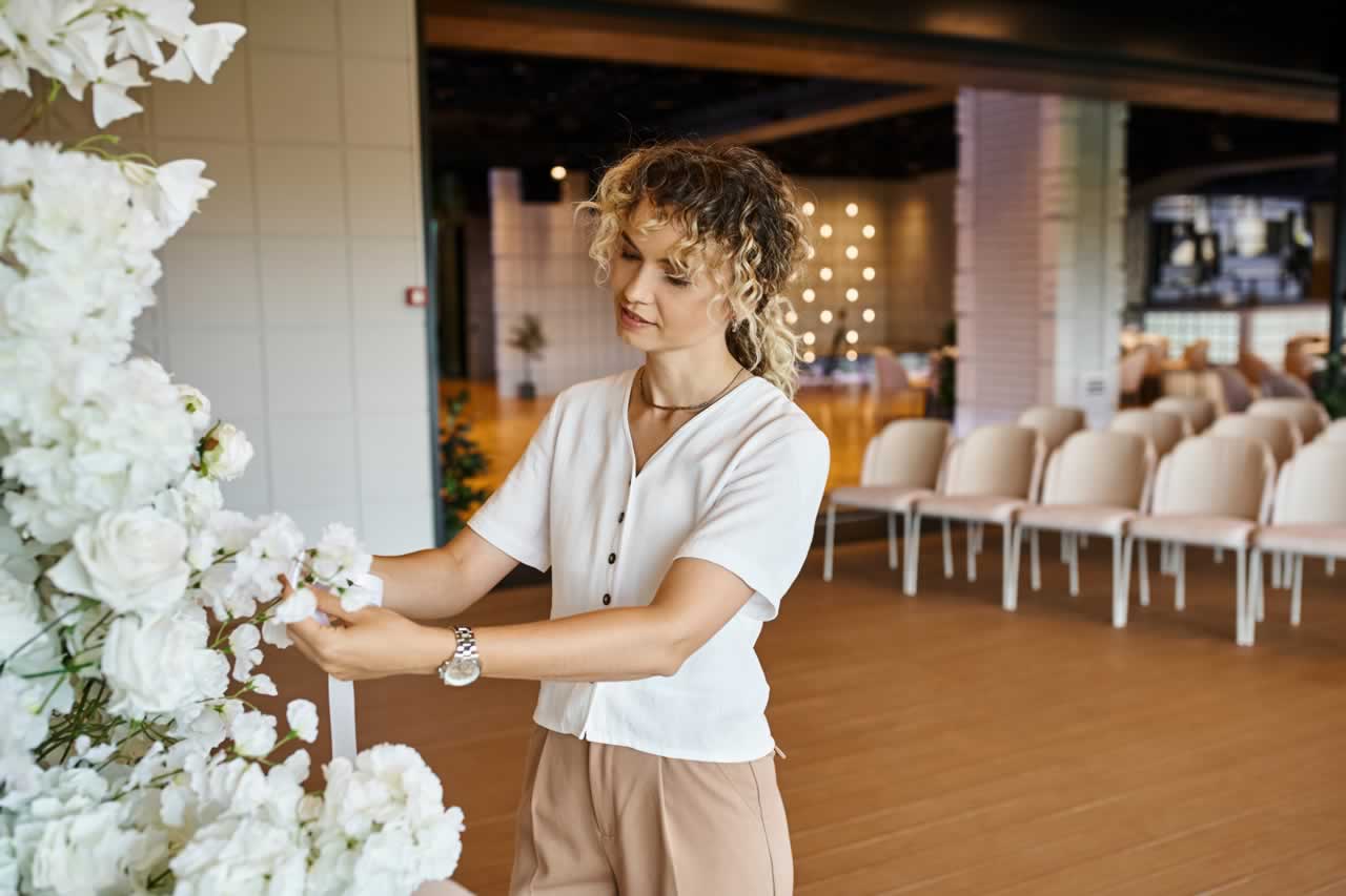 blonde-florist-with-wavy-hair-arranging-white-flor-2023-11-27-05-01-57-utc-s How to Choose the Perfect Vow Renewal Venue: Tips for Finding the Right Fit for Your Vision and Budget
