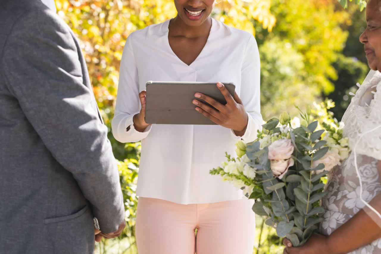 happy-biracial-female-marriage-officiant-with-tabl-2023-11-27-04-56-53-utc-s Vow Renewal vs. Wedding: Understanding the Key Differences