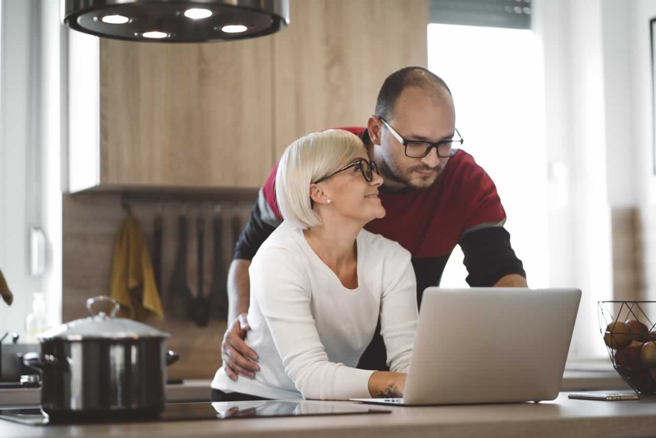 happy-caucasian-couple-working-from-home-together-2024-10-08-01-38-06-utc-m Plan the Perfect Second Honeymoon: Romantic Getaway Ideas After Your Vow Renewal