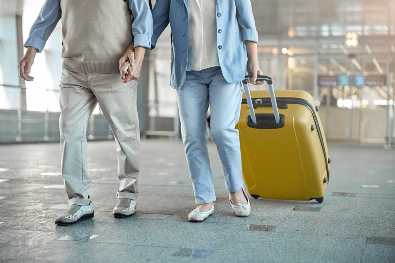 man-and-his-female-spouse-with-baggage-2024-10-18-17-26-00-utc-s Ultimate Travel Essentials Checklist: Packing Tips and Insurance Must-Haves for a Stress-Free Trip