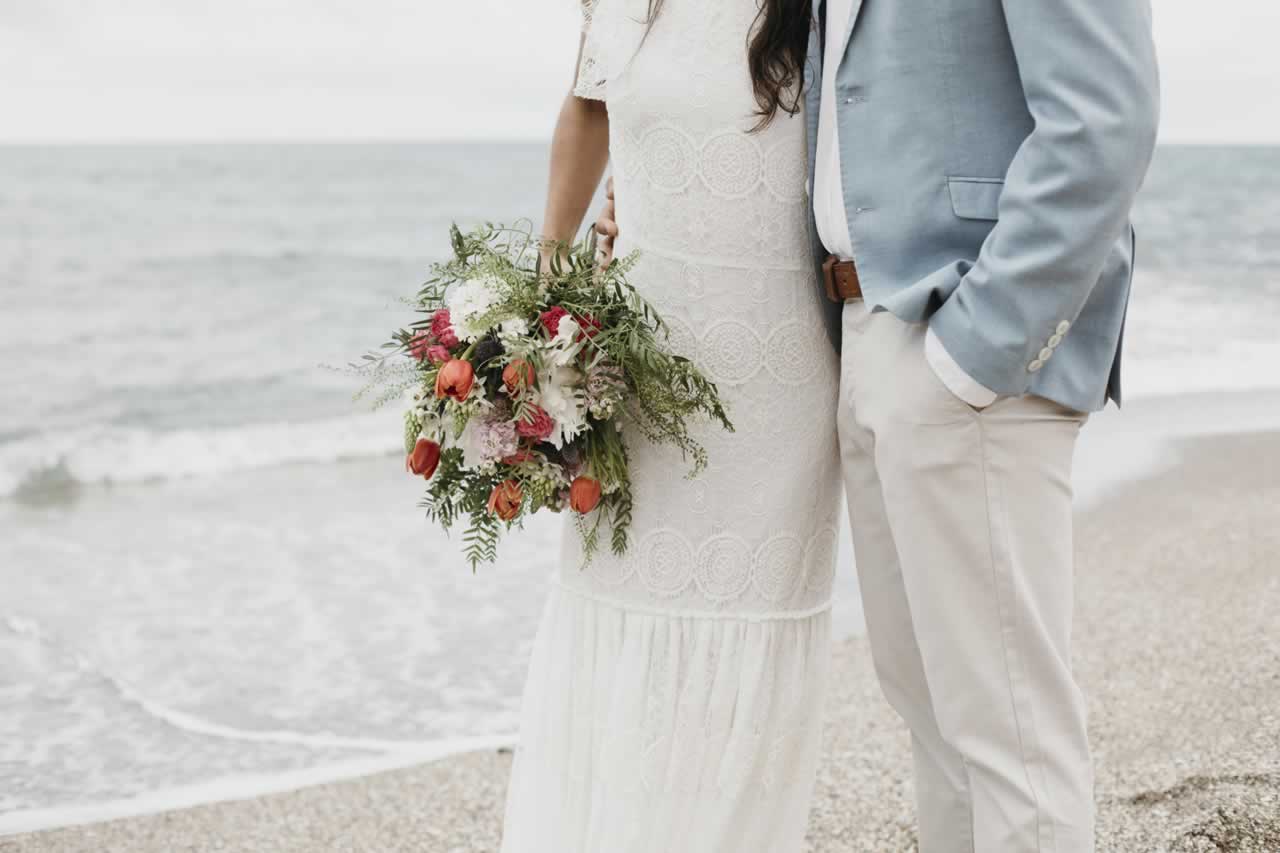 man-woman-having-beach-wedding-s Beach Ceremony Tips: Expert Advice on Planning the Perfect Seaside Celebration