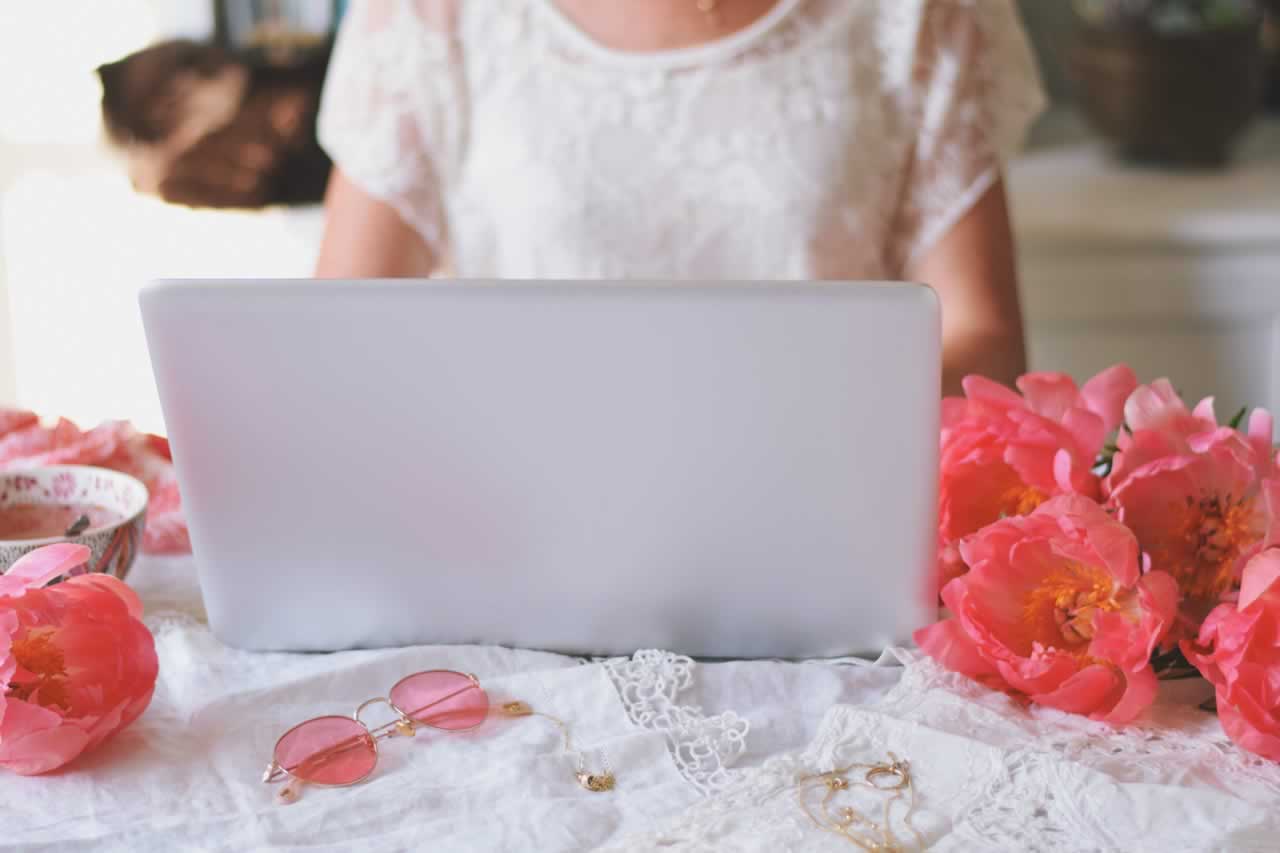 woman-is-sitting-at-a-desk-and-using-laptop-comput-2023-11-27-05-06-30-utc-s Tech-Savvy Vow Renewals: How to Incorporate Technology into Your Vow Renewal: The Ultimate Guide